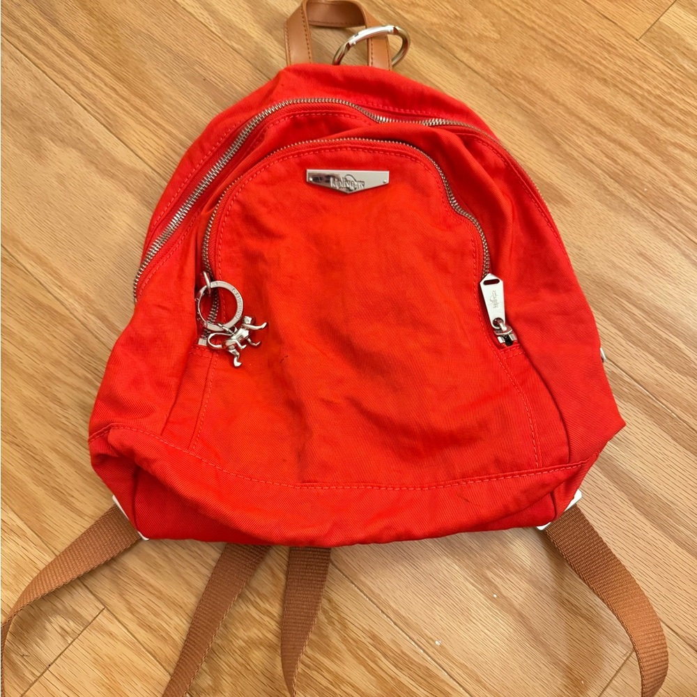 Kipling Red and Silver Backpack with Durable Fabric and Rounded Shape